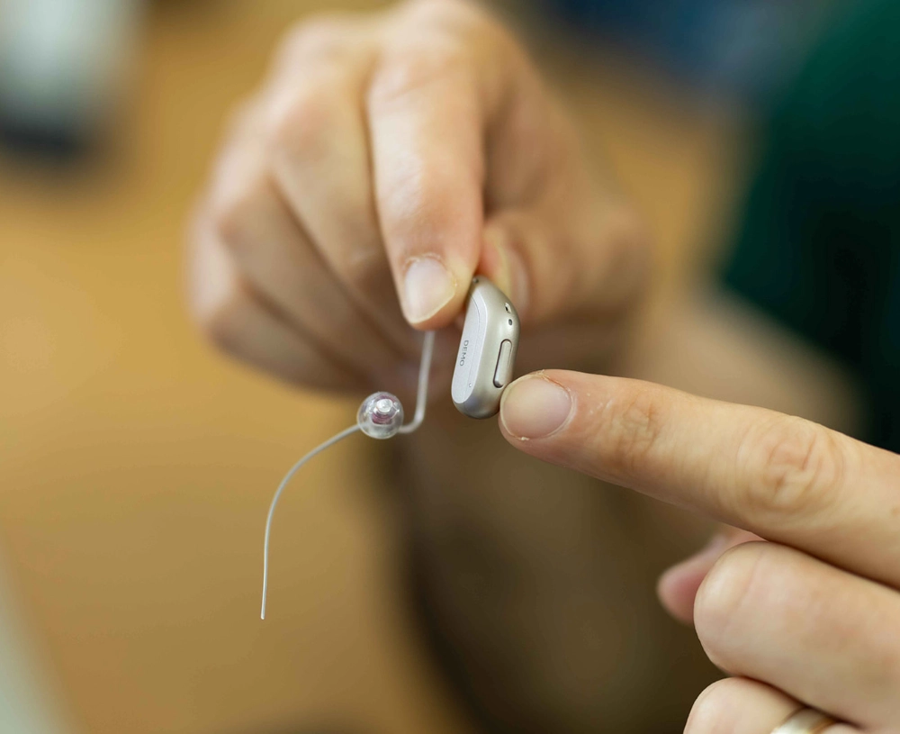 Hearing aid being held by wearer