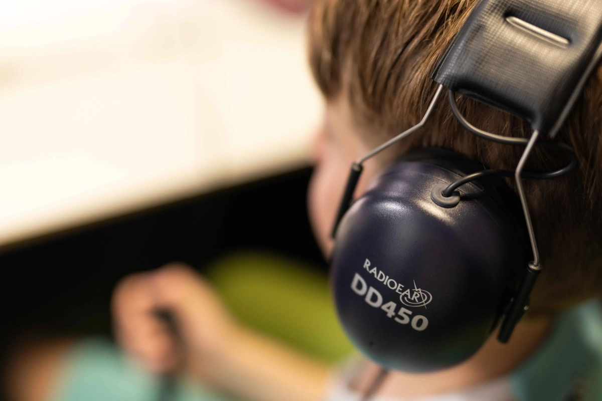Holistic Hearing young person with earphones